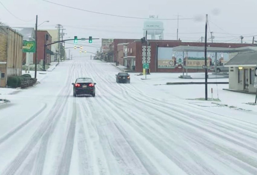 Cars navigate down west Beacon Street Monday as a winter storm dropped a mixture of sleet, snow and ice throughout Neshoba County and much of Mississippi. Business throughout the county remained closed on Tuesday. The low was 18 degrees.